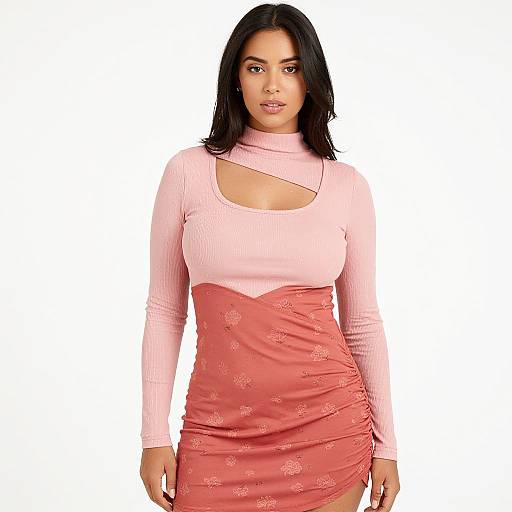 Photograph of a curvy woman with medium brown skin, black shoulder-length hair, wearing a pink long-sleeve top and ruched,