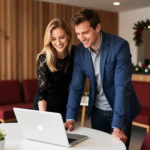 Joyful Couple with Laptop in Cozy Setting