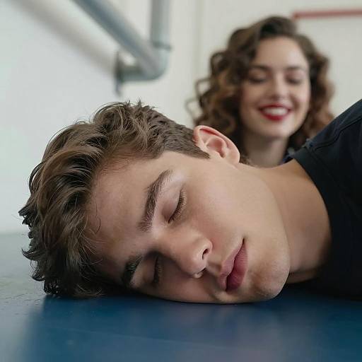 Young Man Resting with Smiling Woman in Background