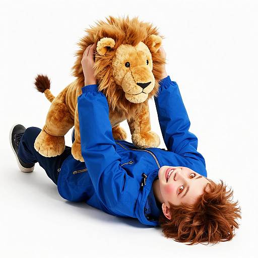 Joyful Boy Playing with Plush Lion