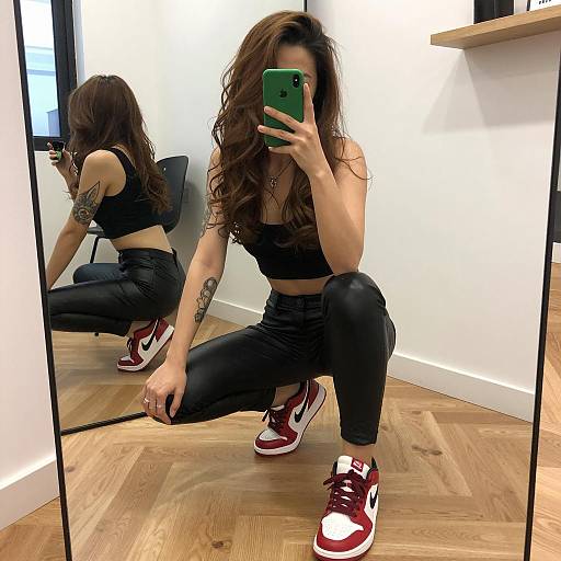 Woman Squatting in Front of Mirror with Green Phone