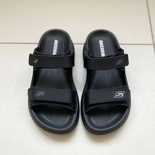 Black Skechers Sandals on Tiled Floor