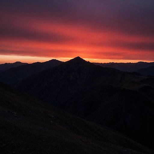 Crimson Sunset Over Rugged Mountain Peaks