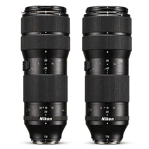 Photograph of two black Nikon zoom lenses with detailed markings, standing vertically side by side against a white background.