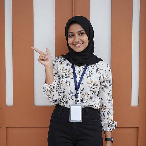 Smiling Woman in Black Hijab Pointing