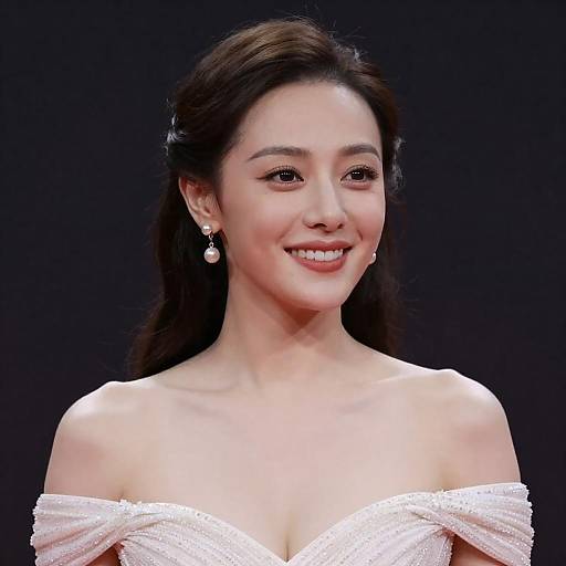 Smiling Woman in Pearl Earrings and Sparkling Off-Shoulder Dress