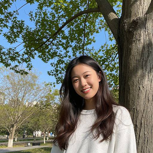 Smiling Woman by Tree on Sunny Day