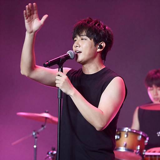 Passionate Male Singer on a Dim Stage