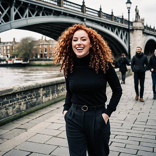 Laughing Woman with Curly Red Hair by Historic Bridge