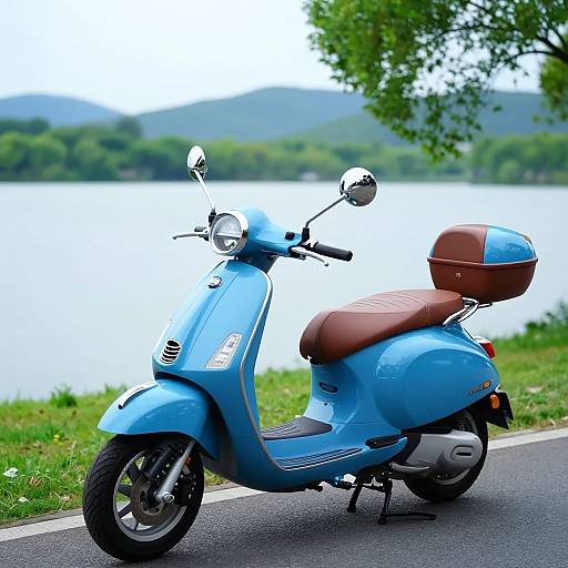 Photograph of a light blue vintage-style scooter with a brown seat and brown rear cargo box, parked on a roadside by a serene lake with green trees