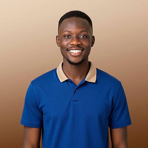 Photograph of a smiling African-American man with short hair, wearing a blue polo shirt with a beige collar, against a gradient brown background.