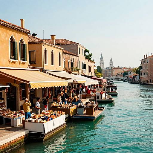 Photograph of a vibrant Venetian canal with sunny yellow buildings, outdoor cafes, bustling customers, and boats docked along the turquoise water.