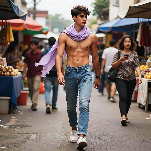 Photograph of a muscular, shirtless young man with a purple scarf, blue jeans, and white sneakers walking down a busy, colorful street market with