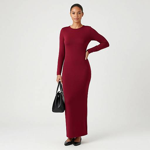 Photograph of a confident, dark-skinned woman with an athletic build, wearing a long-sleeve, deep red dress, black handbag,