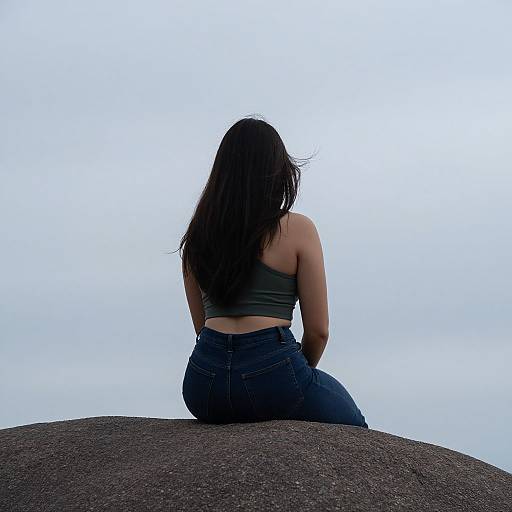 Rear View Woman on Rock