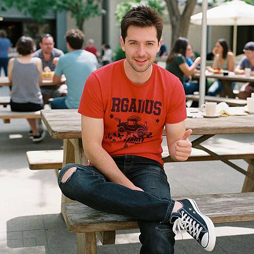 Photograph of a smiling, fair-skinned man with short brown hair, wearing a red 