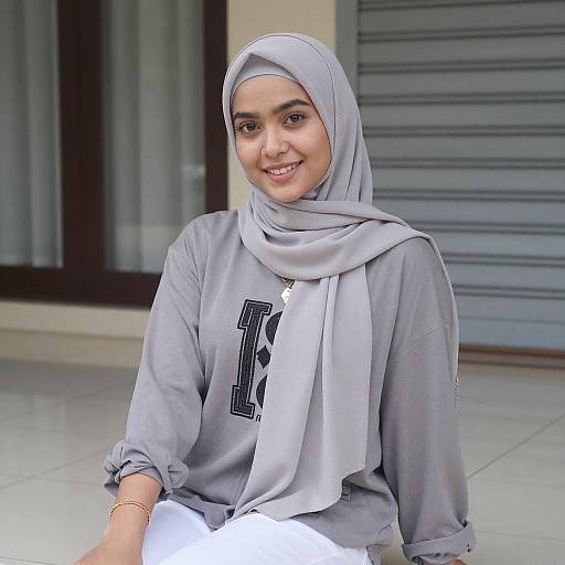 Smiling Woman in Gray Hijab Sitting