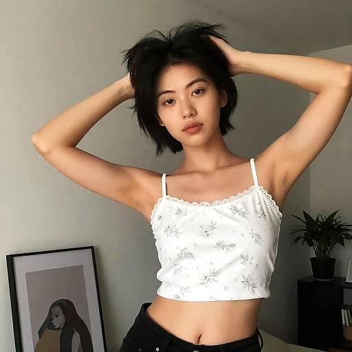 Young Woman Adjusting Hair Indoors