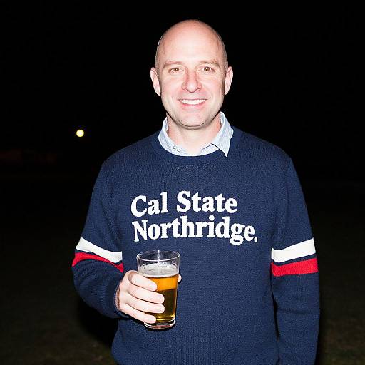 Smiling Man with Beer at Night