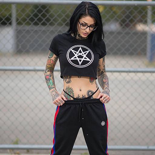 Tattooed Woman by Chain-Link Fence