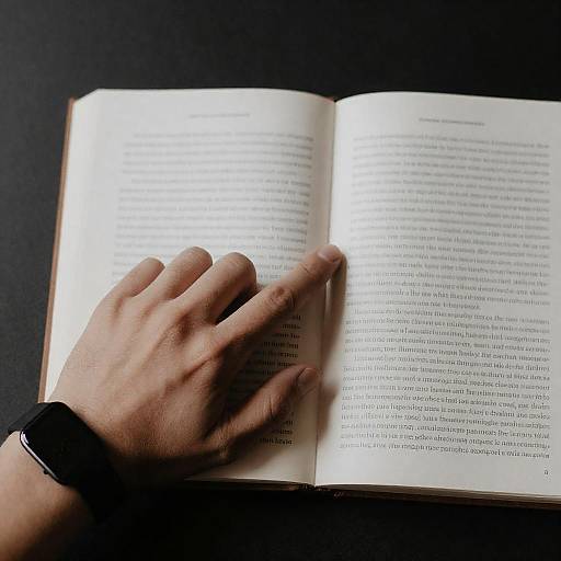Hand Pointing at Book in Dark Setting