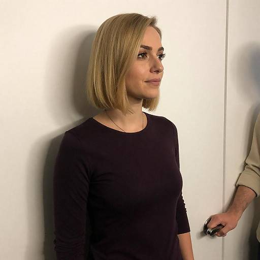 Blonde Woman Standing Against White Wall