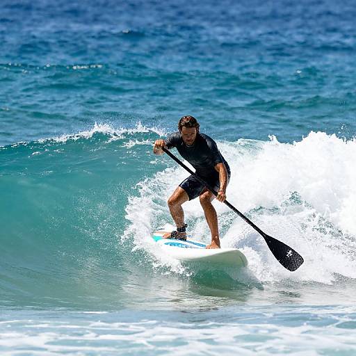 Athlete Paddleboarding on Turquoise Wave