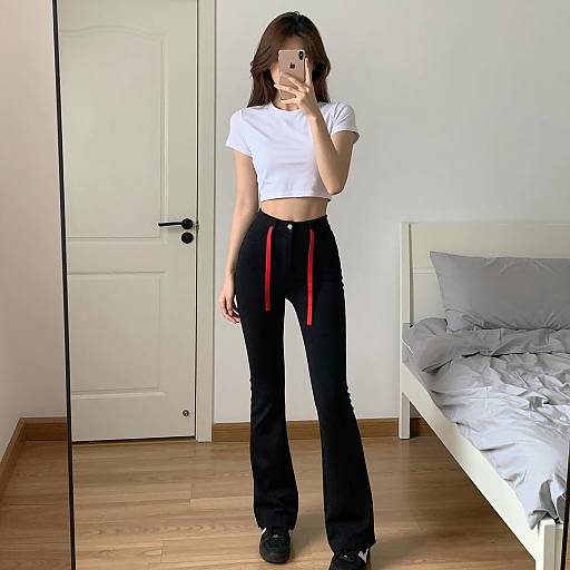 Young Woman Taking Mirror Selfie in Minimalist Bedroom