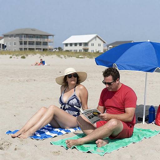 Couple Relaxing on Beach Towels Under Umbrella