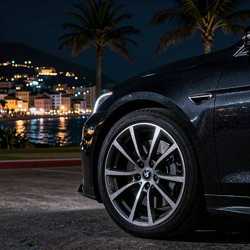 Shimmering Black Car Wheel at Night