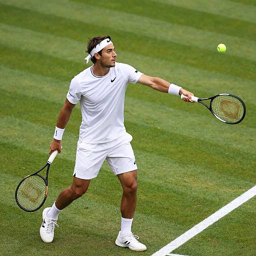 Male Tennis Player Serving on Grass Court