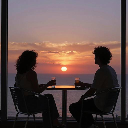 Silhouetted Couple Watching Sunset by the Sea