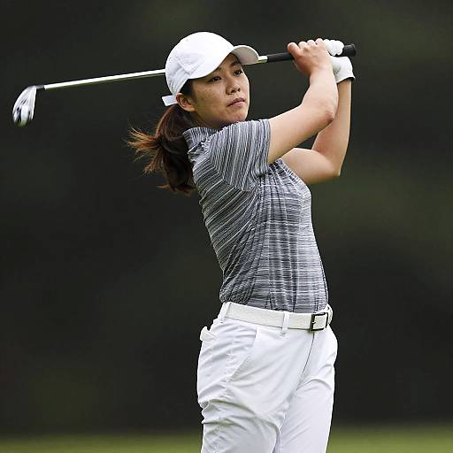 Low-Angle Female Golfer Mid-Swing