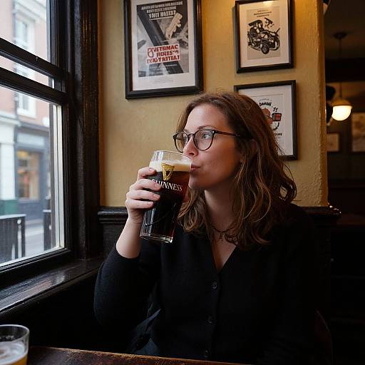 Woman Enjoying Guinness in Cozy Pub