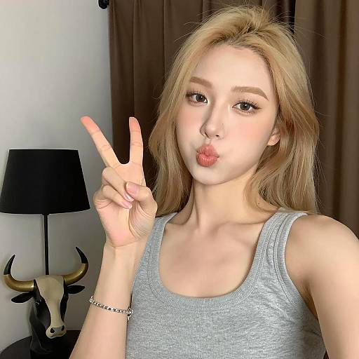 Blonde Woman Posing with Peace Sign