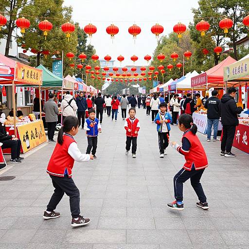Photograph of a lively outdoor Chinese street festival with children in red and black martial arts uniforms, red lanterns hanging overhead, colorful vendor stalls, and