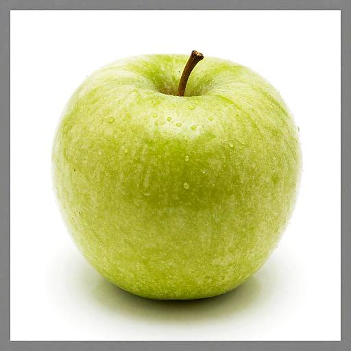 Photograph of a fresh, green apple with small water droplets on its surface, centered against a white background with a gray border.