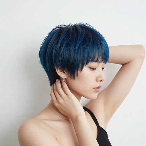 Photograph of an East Asian woman with short, vivid blue hair, closed eyes, black sleeveless top, gold earrings, and hand touching neck,