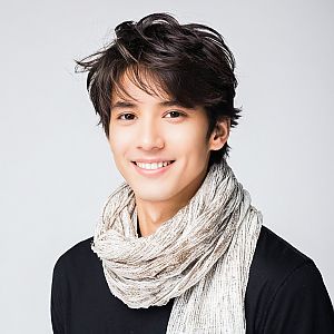 Young Man with Warm Smile in Scarf