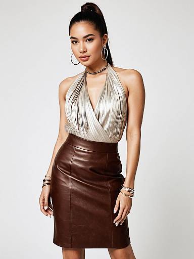 Modern Chic Woman in Beige Halter Top and Brown Leather Skirt