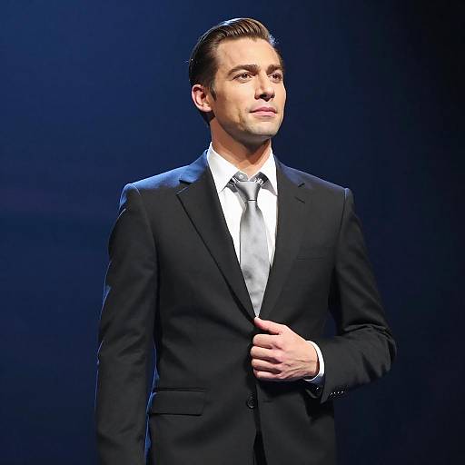 Confident Young Man in Black Suit and Silver Tie