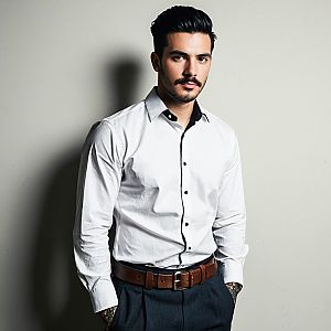 Young man in stylish white party shirt with black accents