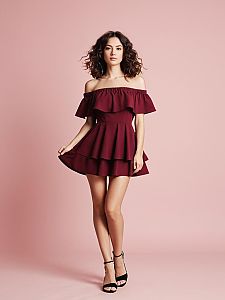 Woman in Modern Burgundy Off-the-Shoulder Mini Dress with Flowing Ruffles
