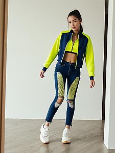 Trendy Woman in Neon Yellow and Navy Athleisure Outfit with Distressed Jeans