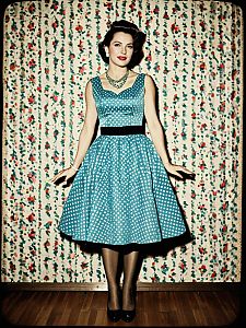 Retro 1950s Woman in Blue Polka Dot Party Dress Full Body Vintage Fashion