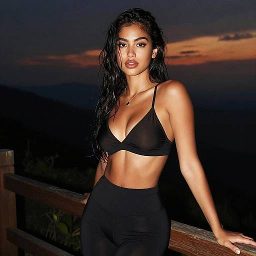 Confident Woman Wearing Black Bralette and Leggings at Sunset