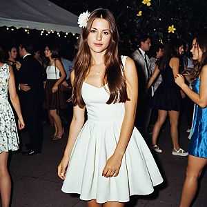 Young Woman in White Dress at Evening Event