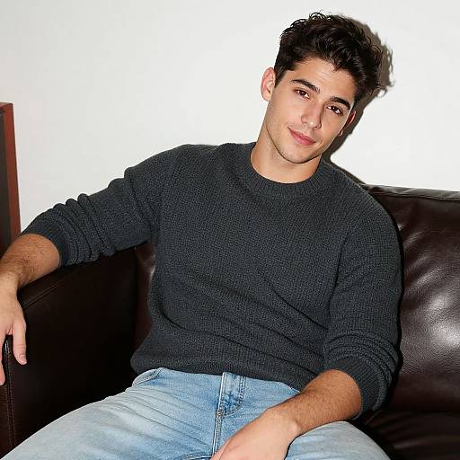Young Man in Gray Sweater Sitting on Leather Couch Casual Portrait