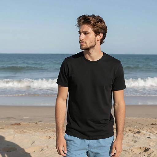 Young Man Wearing Black T-Shirt and Blue Shorts at the Beach