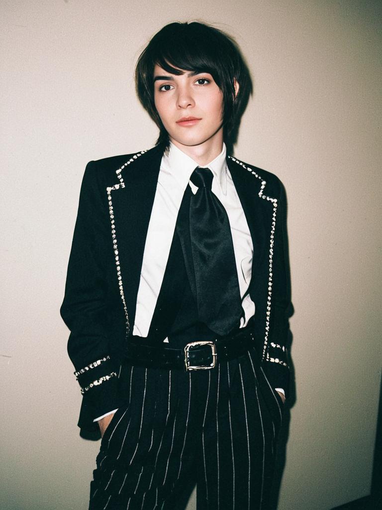 Man in Stylish Femboy Costume with Pinstripe Pants and Studded Blazer